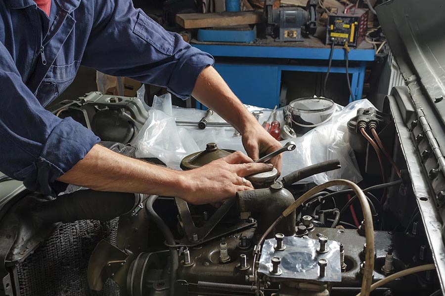Mechanic performing vehicle maintenance