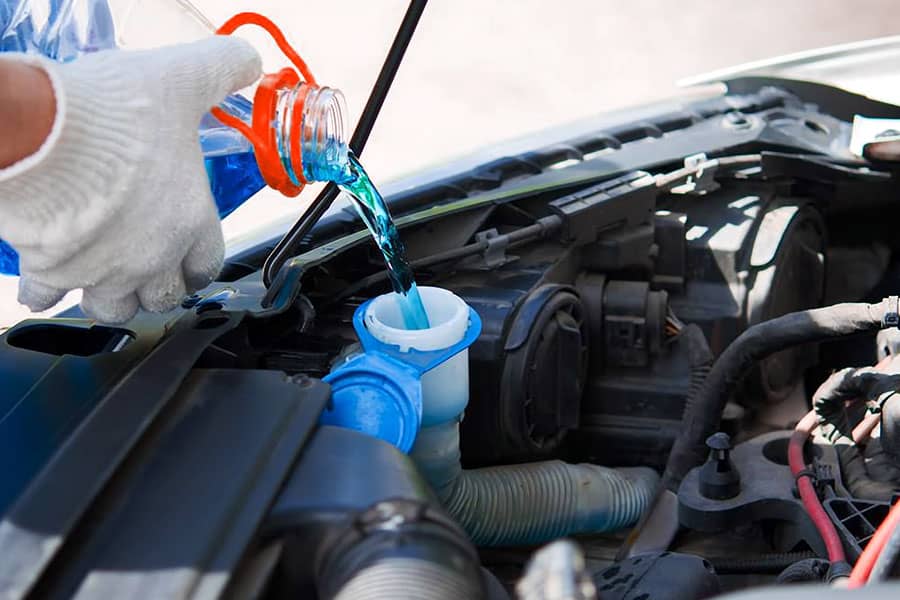 Man Pouring coolant in car