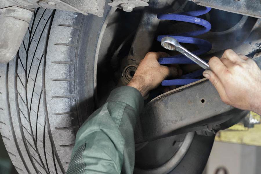 Mechanic adjusting a car suspension