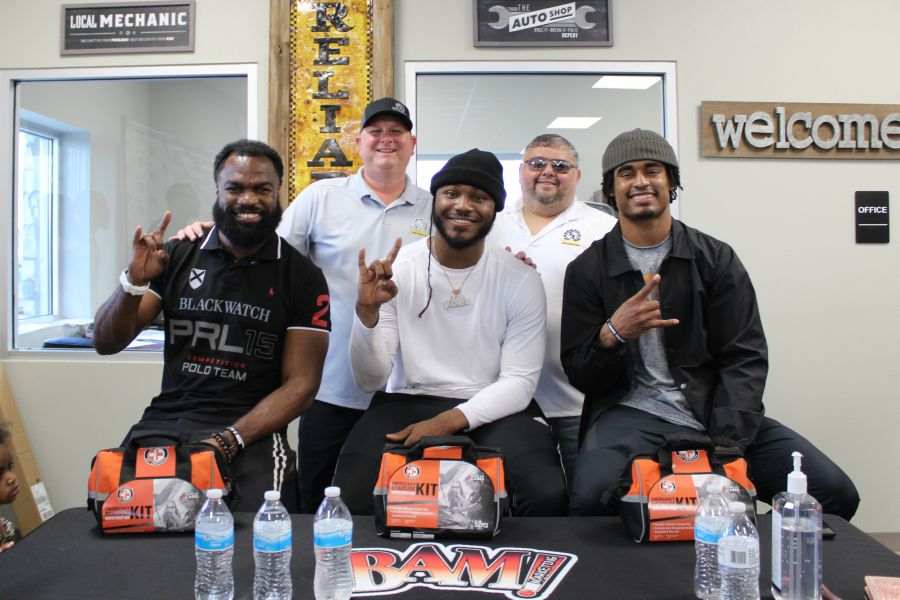 Reliable Automotive owners posing with Longhorn players