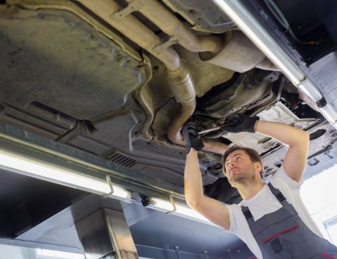 Man performing car maintenance