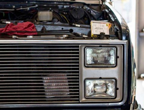 Truck with dimmed headlights being inspected at Reliable Automotive in Kyle TX