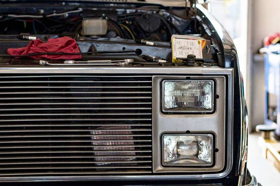 Truck with dimmed headlights being inspected at Reliable Automotive in Kyle TX
