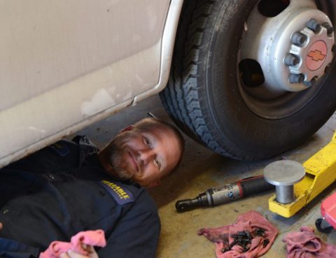 Mechanic changing oil in vehicle