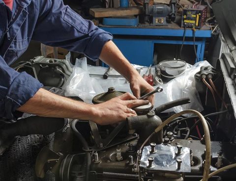 Mechanic performing vehicle maintenance