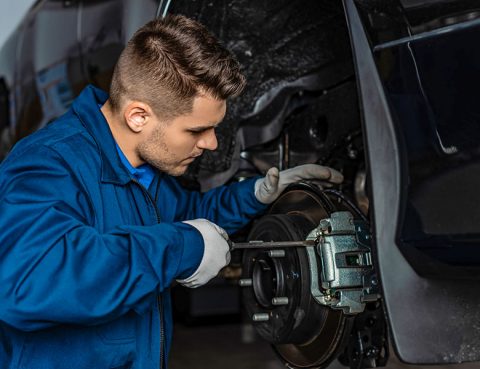 Mechanic performing vehicle maintenance