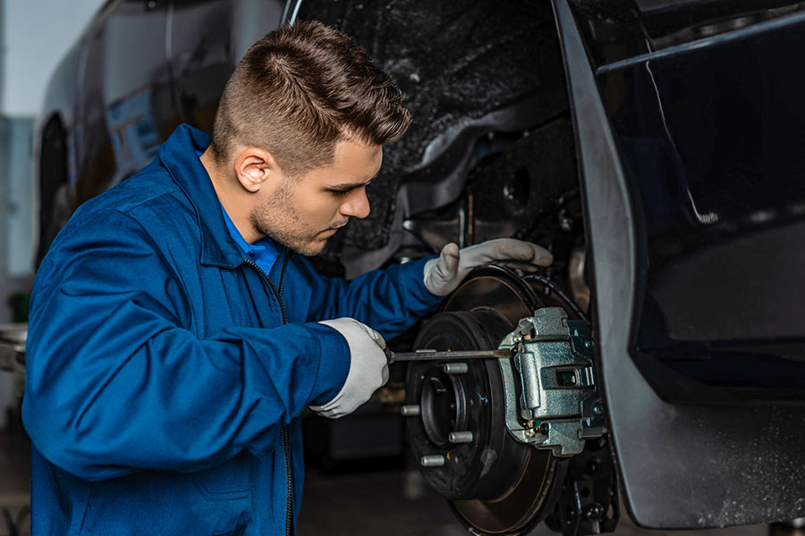 Mechanic performing vehicle maintenance