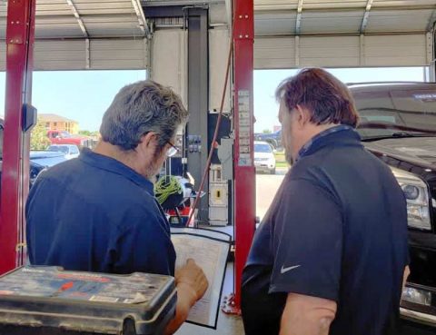 Mechanic discussing an auto issue with a customer.