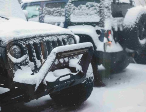 Jeeps covered in snow in the winter