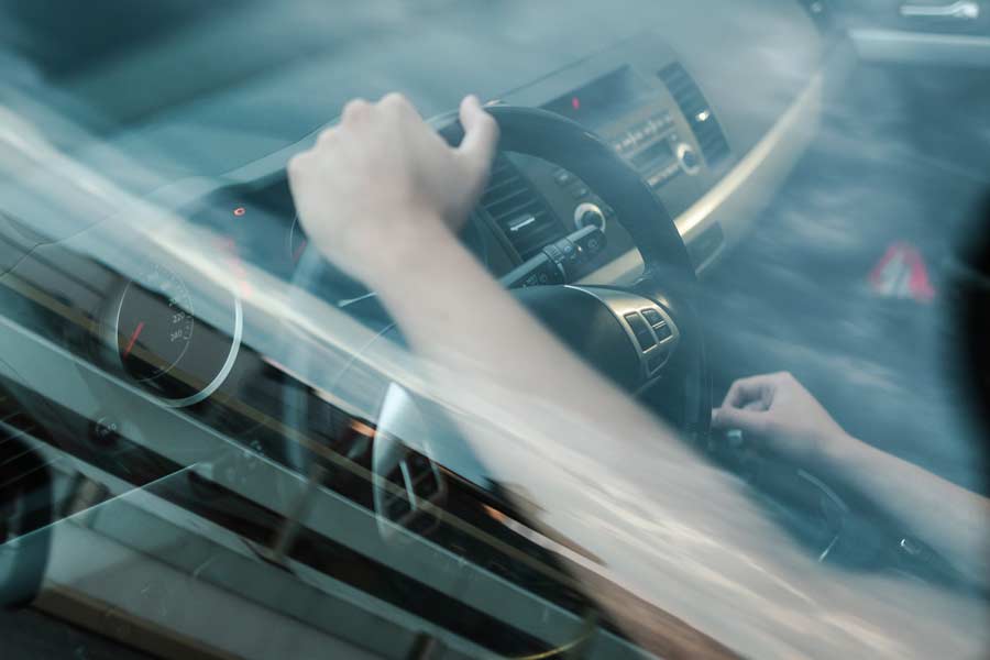 Woman shifting gears while driving
