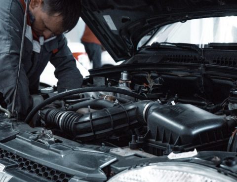 mechanic doing a coolant flush on a vehicle