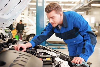 auto mechanic inspecting car engine